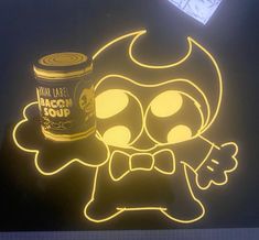 a neon sign with a cartoon character next to a can of macaroni soup