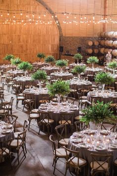 tables and chairs are set up in an old wine cellar for a wedding or event