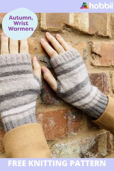 two hands wearing knitted mittens against a brick wall with the text autumn, wrist warmers free knitting pattern