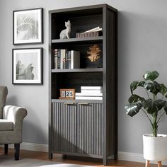 a living room with a chair, bookcase and pictures on the wall above it