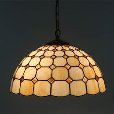 a stained glass light hanging from a chain