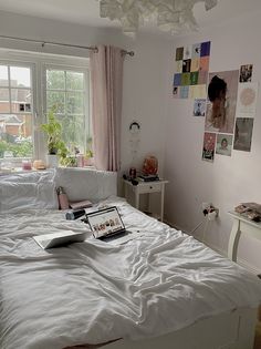 a bed room with a neatly made bed and a laptop