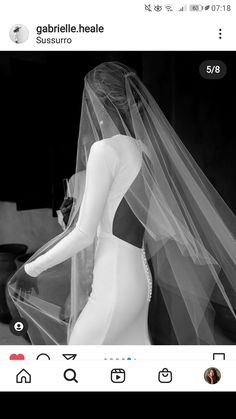 a black and white photo of a woman in a wedding dress with a veil on her head