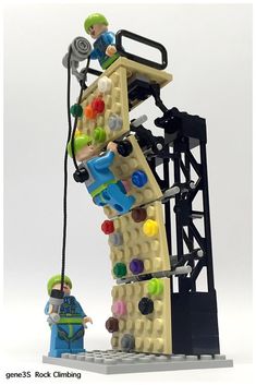 a lego man standing next to a tall tower with lots of items on top of it