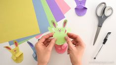 someone is making an easter bunny out of paper