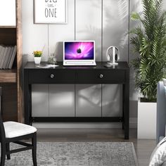 a laptop computer sitting on top of a wooden desk next to a chair and bookshelf