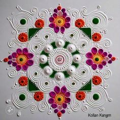 an intricately designed paper work with colorful flowers and swirls on the surface,