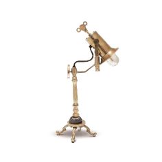 an antique brass desk lamp on a white background