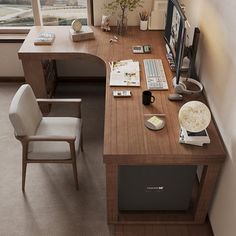 a desk with a chair and computer on it in front of a window that looks out onto the ocean