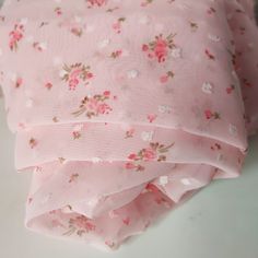 three pink flowered cloths stacked on top of each other