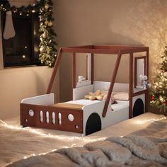 a child's bed made to look like a train with lights on the side