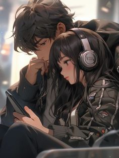 two people sitting next to each other with headphones on and one holding a tablet