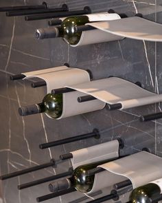 several wine bottles are lined up on the wall