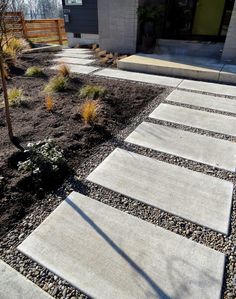 a concrete walkway in front of a house