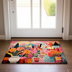 a colorful rug on the floor in front of a door