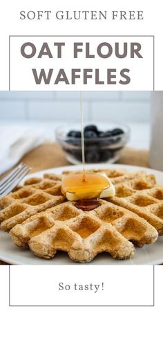 a white plate topped with waffles on top of a table next to syrup