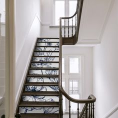 a stair case with blue flowers painted on it