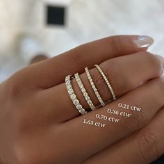 a woman's hand with three diamond rings on her finger and the width of each ring