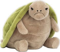 a stuffed turtle with a green leaf on its head and eyes, sitting in front of a white background