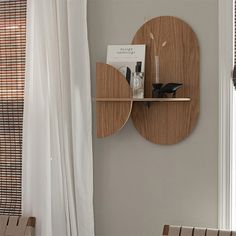 a wooden shelf mounted to the side of a wall