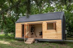 a tiny house is built into the grass