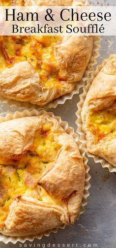 ham and cheese breakfast souffle is shown in muffin cups on a baking sheet