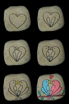 four rocks with hearts and two birds painted on them