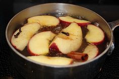 apples are being cooked in a pot on the stove