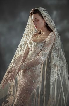 a woman in a wedding dress with a veil on her head