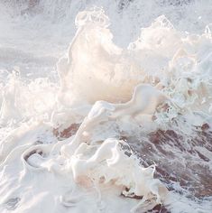 the water is splashing on top of the foamy waves in the ocean,