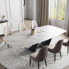 a dining table with chairs around it and a rug on the floor in front of it