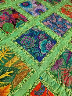 a colorful quilt with many different designs on it