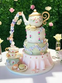 there is a cake on the table with tea cups and saucers in front of it