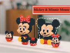 three mickey and minnie mouse figurines sitting on top of a table with the words mickey & minnie mouse