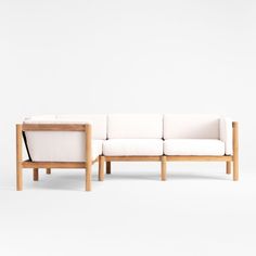 a white couch sitting on top of a wooden frame