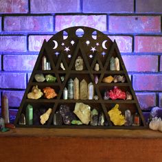 a shelf filled with rocks and crystals on top of a wooden table