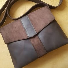 a brown and black purse sitting on top of a table