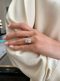 a woman's hand with a diamond ring on it