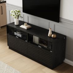 a flat screen tv mounted to the side of a wooden entertainment center in a living room