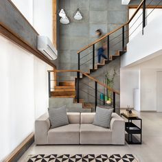 a living room with a couch and some stairs