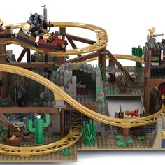 a lego model of a roller coaster with people riding on the top and bottom tracks