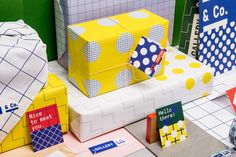 several boxes are stacked on top of each other in different colors and patterns, all with polka dots