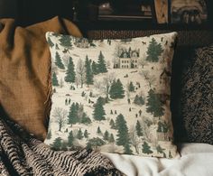 a pillow sitting on top of a couch next to a blanket