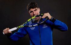 a man holding a tennis racquet on top of a black background in front of his face