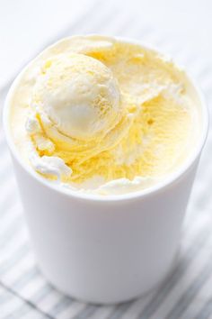 a white bowl filled with ice cream on top of a table