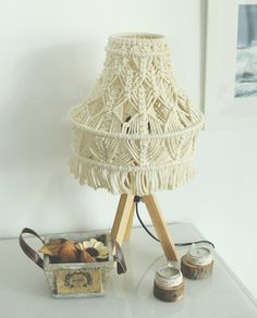 a lamp that is on top of a table next to some jars and other items