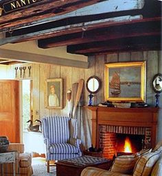 a living room filled with furniture and a fire place under a mantel above the fireplace