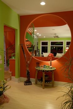 a living room filled with furniture and a large round mirror