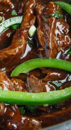 beef and green peppers in a sauce with brown gravy on the side, ready to be eaten