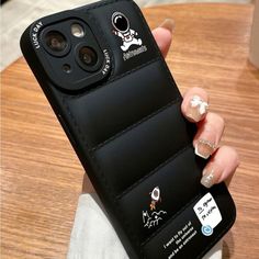 a woman's hand holding an iphone case with stickers on it